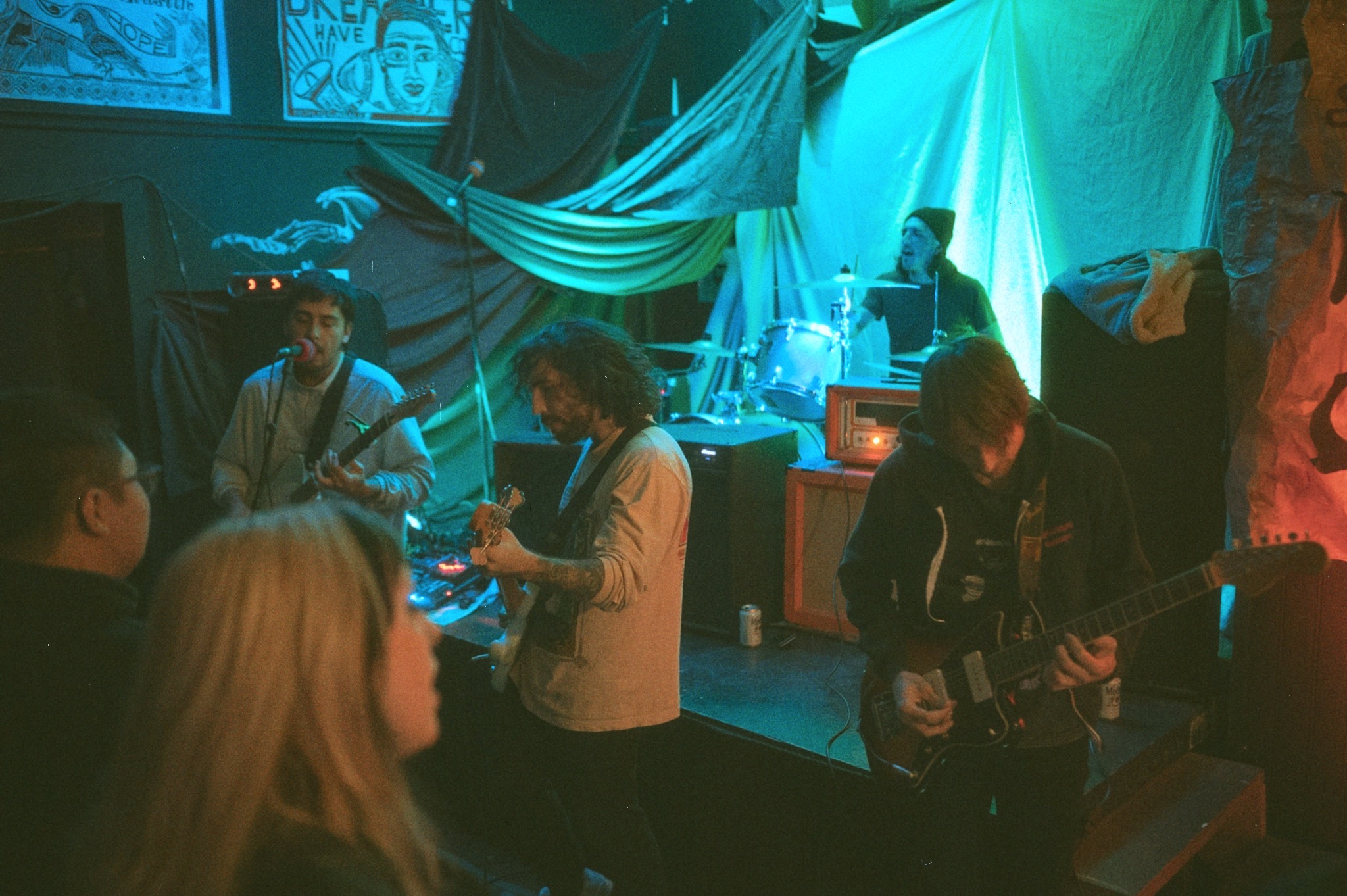 Geoff Nelson performing with a band in an intimate room